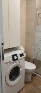 a bathroom with a washing machine and a toilet at Appartement Girasol Puerto de la Cruz, plaza Charco in Puerto de la Cruz