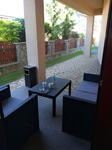 a patio with two chairs and a table and a television at Penzión Villa in Rajecké Teplice