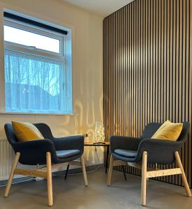 two chairs sitting in a room with a window at Cozy Bungalow in Reykjavík