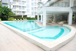 a swimming pool in front of a building at 2-Bedroom Boutique City Condo - Newly Renovated! in Cebu City