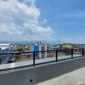 a balcony with a view of a city at Rumah Gaharu in Bandung
