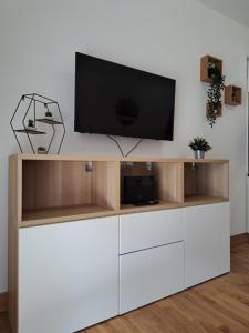 a tv on top of a white entertainment center at Angy's house Roma in Rome