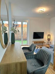 ein Wohnzimmer mit einem Sofa und einem Tisch in der Unterkunft Moderne Erdgeschosswohnung in Augsburg