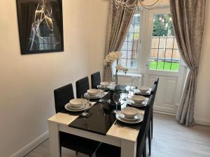 a dining room with a table and chairs and a window at Lingfield House - Spacious 3 Bed Detached Home From Home in Burton upon Trent