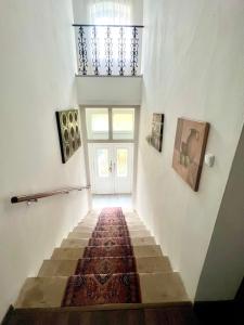 a hallway with a staircase with a rug on the floor at Stilvolles Studio- Apartment mit einzigartiger Aussicht in Baden