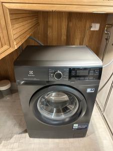a washing machine in a kitchen with a cabinet at Levi Aurora Sky in Levi +11 photos
