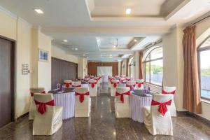 a room with rows of tables and chairs with red bows at REVENIIR RESORT Lonavala in Lonavala