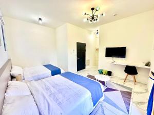 Postel nebo postele na pokoji v ubytování 睡飽飽民宿 Sleeping Well B&B 全新電梯民宿
