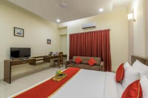 a bedroom with a large bed and a living room at REVENIIR RESORT Lonavala in Lonavala