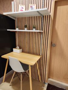 a desk with a chair and a table and shelves at 205Homely Private room in apartment Near BTS KU St in Ban Yang