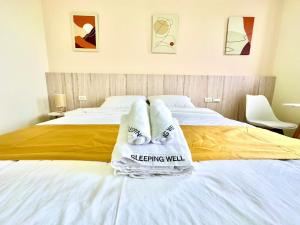 Postel nebo postele na pokoji v ubytování 睡飽飽民宿 Sleeping Well B&B 全新電梯民宿