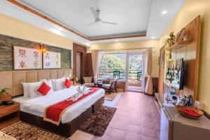 a hotel room with a bed and a balcony at Veda5 Ayurveda & Yoga Retreat in Rishīkesh