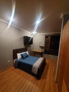 a bedroom with a bed with lights on the ceiling at hermosa casa en cuenca in Cuenca