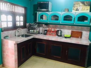 a kitchen with a sink and a counter top at Unakuruwa silent beach villa in Tangalle