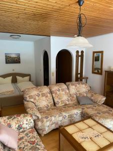 a living room with a couch and a bed at Schwarzwaldblick in Triberg