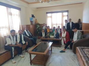 a group of people posing for a picture in a room at Mayel-Lyang Residency in Gangtok