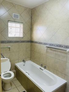 a bathroom with a white tub and a toilet at Ramsgate Beach house in Margate