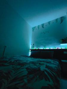 a dark room with a bed with lights on it at RDTROOM At Aeropolis in Teko