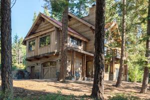 a log home in the woods with trees at North Shore Bliss by Tahoe Getaways - 3 BR plus loft & Private Hot Tub in Carnelian Bay