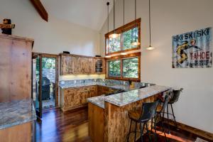 a kitchen with wooden cabinets and a large island at North Shore Bliss by Tahoe Getaways - 3 BR plus loft & Private Hot Tub in Carnelian Bay