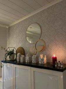 a counter with a candle and a mirror at Villa Aurora View in Rovaniemi