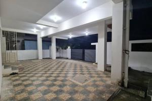 an empty room with white walls and a tile floor at Kamalam 2 BHK - Non AC in Coimbatore