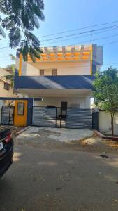 a house with a gate in front of a garage at Kamalam 2 BHK - Non AC in Coimbatore