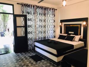 a bedroom with a large bed and a window at Unakuruwa silent beach villa in Tangalle