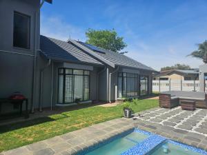 a house with a swimming pool in the yard at Villa La Sola B&B and Self-Catering in Boksburg