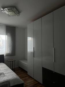 a bedroom with a bed and a large white cabinet at Ferienwohnung Patrick in Amberg