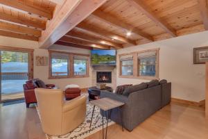 a living room with a couch and a fireplace at Olympic Valley Hideaway - Newly Remodeled Cabin with Private Hot Tub in Olympic Valley