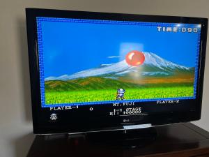 a television screen with a picture of a mountain at Cortijo Mazarrón in Güéjar-Sierra +11 photos