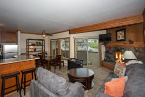 a living room with a couch and a fireplace at Palisades Tahoe Ski Condo - Remodeled 2 BR, Walking Distance to Lifts & Village in Olympic Valley