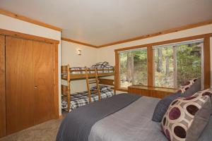 a bedroom with a bed and a bunk bed at Palisades Tahoe Ski Condo - Remodeled 2 BR, Walking Distance to Lifts & Village in Olympic Valley