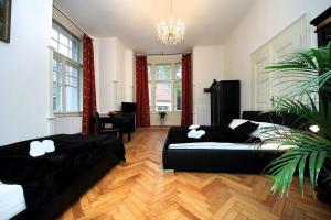 a bedroom with two beds and a chandelier at Cosy Apartment for 4 / Old Town / Jewish Quarter in Prague