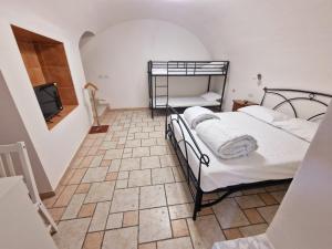 a bedroom with two bunk beds and a television at SENTIERI DEL GARDA in Arco