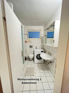 a bathroom with a toilet sink and a washing machine at Monteurwohnungen - Monteurunterkunft in Randersacker bei Würzburg in Randersacker