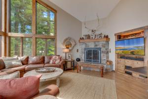 a living room with a couch and a fireplace at Tahoe Point of View - Amazing Lake Views at this 4BR w Hot Tub, Sauna, Near Skiing in Tahoe City