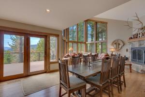 a dining room with a table and chairs and a fireplace at Tahoe Point of View - Amazing Lake Views at this 4BR w Hot Tub, Sauna, Near Skiing in Tahoe City