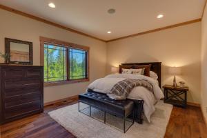 a bedroom with a bed and a dresser and a window at Starlight Retreat at Gray's Crossing in Truckee