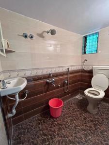 a bathroom with a toilet and a sink at Shobha Niwas in Nandgaon
