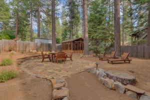 a patio with a table and benches in a yard at Tahoe Time on North Shore - 4 BR Cabin w Private Hot Tub, Pet Friendly, Walk to Dining in Tahoe Vista
