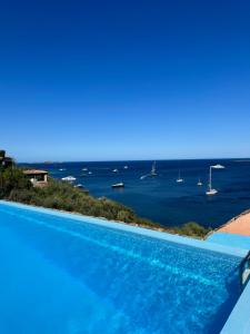 a swimming pool with a view of the ocean at Studio flat in Sardinia Costa Smeralda in Porto Rotondo