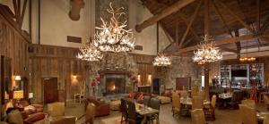 a large room with a fireplace and chandeliers at Cozy Mountain View Condo in Vernon Township
