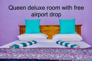 a bedroom with a bed with two pillows at Gloriya Mathews in Negombo