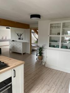 a kitchen with white cabinets and a counter top at Ferienwohnung Hintermoos in Kißlegg