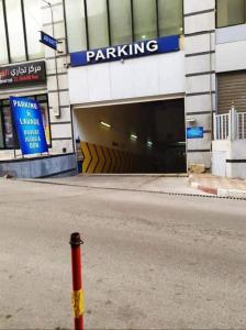 a parking garage with a red and yellow pole in the street at L’oranais in Oran