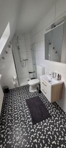a bathroom with a toilet and a sink and a shower at LaPurka ll Home in Nordhorn