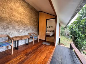 a room with a wooden table and a mirror at Jungle guest house in Mae Hong Son