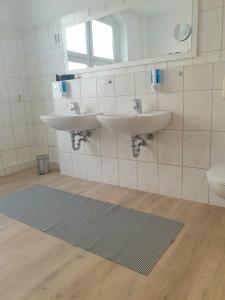 a bathroom with two sinks and a toilet at Zur Altstadt in Plauen